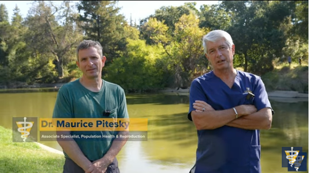 Pitesky and Stetter stand in front of a pond.