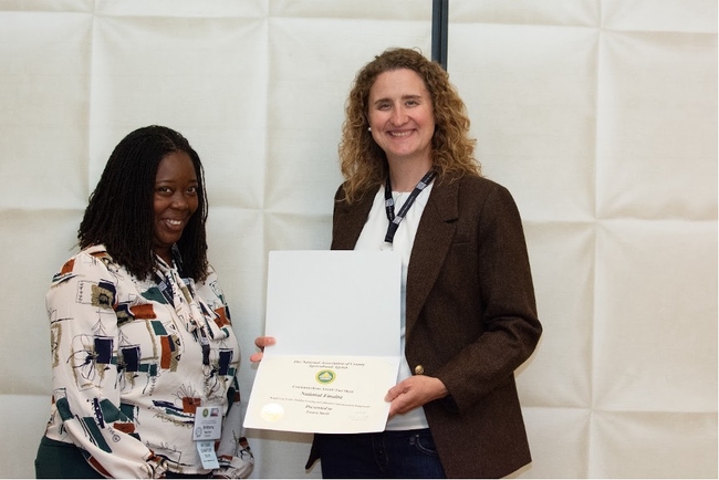 Laura Snell accepts an award for her grazing fact sheet.