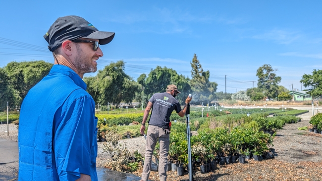 Bruno Pitton (left) observes irrigators measuring water pressure during the training at Generation Growers. Photo courtesy of Bruno Pitton.