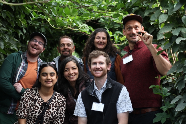 UCCE advisors visit Driscoll's nursery plots and pose with blackberry vines.