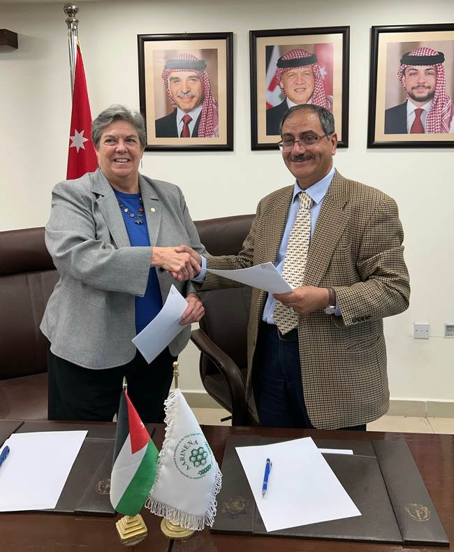 In Jordan, Humiston and AARINENA's Rida Shibli signed agreements for scholar exchanges and joint research.