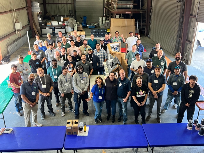 Participants pose for a group photo after completing the exclusion skill-building activity.