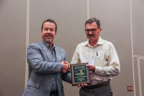 Rick Miller, left, presents award to Steve Fennimore. Photo by Todd Fitchette