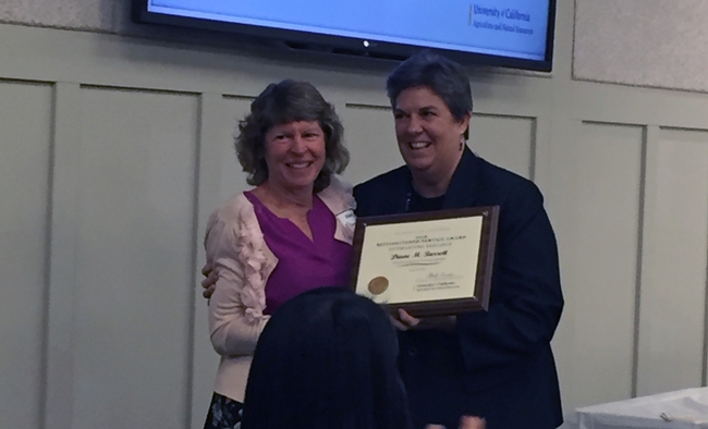 Diane Barrett receives research award from VP Glenda Humiston.