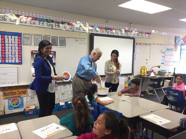 Congressman Jim Costa blends a salad for students at La Vina Elementary School in Madera County as UCCE nutrition educator Angelica Perez observes.