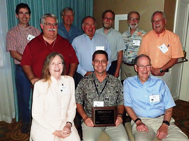 Gerry poses with former recipients of the Lifetime Achievement Award. Front row, from left, are Nancy Hinkle, Gerry, and Dick Miller. Back row, from left, are Phil Kaufman, Chris Geden, Jerry Hogsette, Don Rutz, Dave Taylor, UC Riverside professor Brad Mullens and Wes Watson. Photo by Annie Rich
