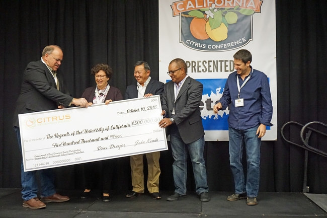 CRB chairman Dave Dreyer presents a giant check to UC Agriculture and Natural Resources representatives, left to right, LREC director Beth Grafton-Cardwell, associate vice president Tu Tran, UC ANR director of major gifts Greg Gibbs, and UCCE plant pathology specialist Georgios Vidalakis.