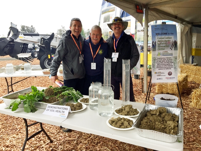 Jeff Mitchell, center, talks about soil health with Scott Brayton of Development Services, left, and Mark Bell, vice provost of of strategic initiatives and statewide programs.