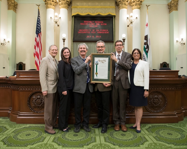 Assemblymembers Cecilia Aguiar-Curry and Bill Quirk presented Jim Farrar with a proclamation honoring UC IPM at the Capitol.