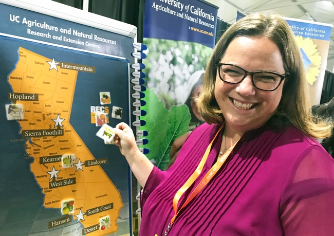 CDFA undersecretary Jenny Lester Moffitt visited the ANR booth and matched all the commodities to UC ANR RECS.