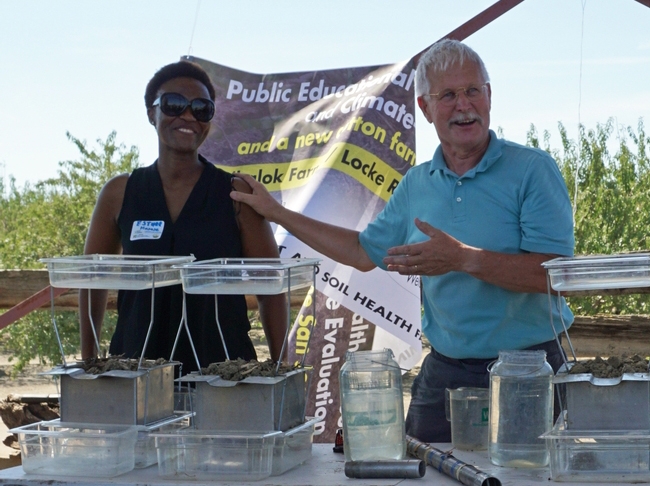 Jeff Mitchell, right, and Esther Mosase, UCCE climate-smart educator, demonstrate soil health at a 2019 field day.