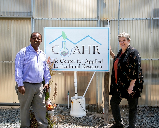 Humiston and Bachie stand on either side of the sign that reads: CfAHR Center for Applied Horticultural Research