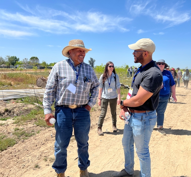 Hanif Houston, right, talks with a farmer during the Small Farms Tour.