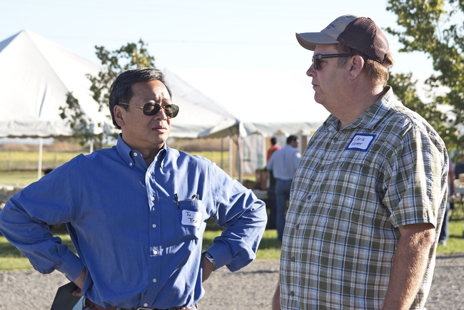 Tu Tran, left, UC ANR vice president for business operations, and Chris Greer, UC vice provost of Cooperative Extension, attended the Rice Field Day in Biggs to announce the creation of the new UCCE Presidential Chair for California Grown Rice.