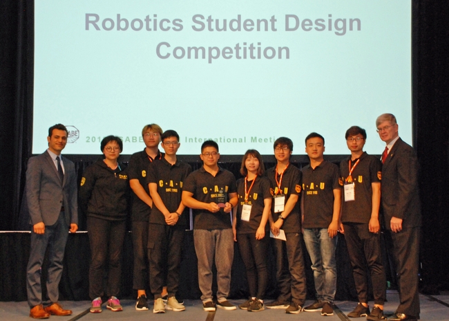 Ali Pourreza, left congratulates China Agricultural University's Dream Team, winner of the ASABE robotics challenge advanced division.