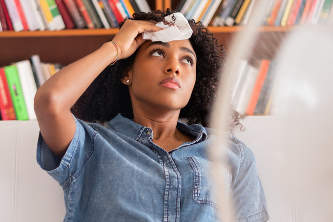 A woman wipes her brow due to extreme heat