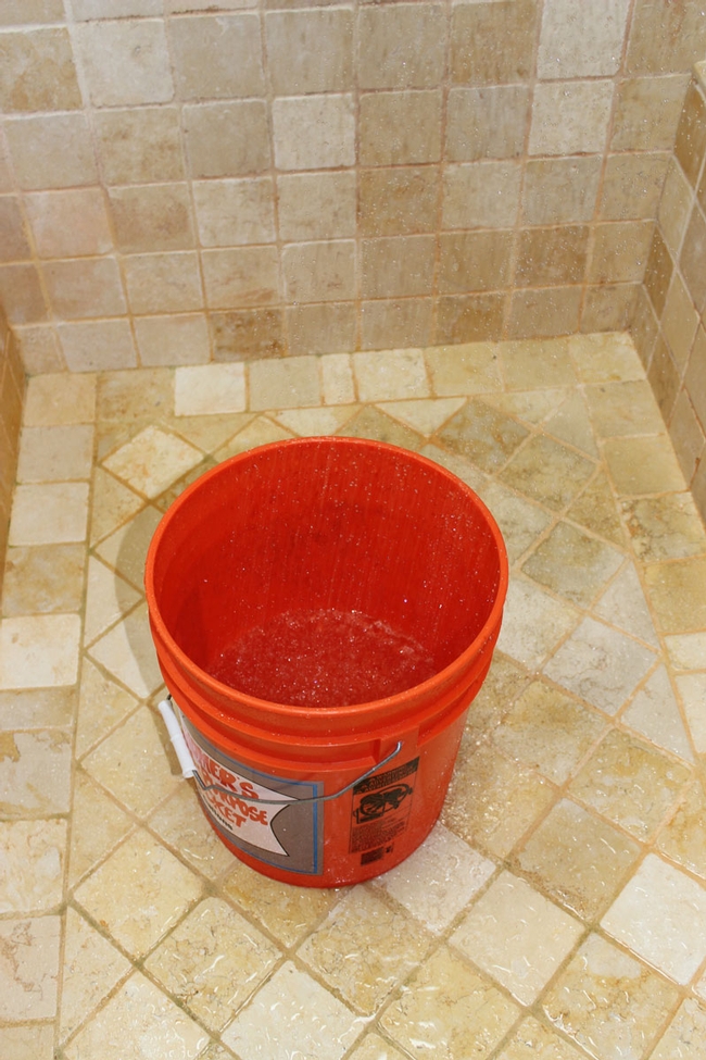 5 gallon bucket in shower to collect water as it heats up.