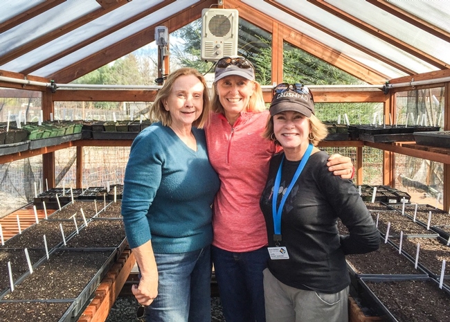 Three Master Gardeners  arm-in-arm in the greenhouse at Our Garden