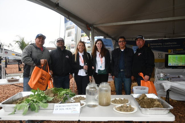 UCCE's Mohammad Yaghmour, UCCE Kern County (second from right) and Jaime Solorio, UC West Side REC, Five Points, CA (far right) visit the CASI / NRCS display site at the World Ag Expo in Tulare, CA - February 13, 2019
