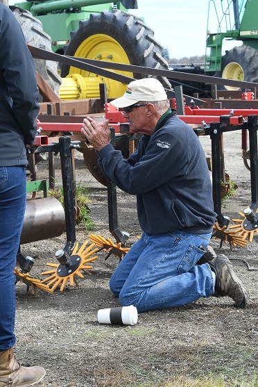 Scott Park, co-host of the CIG Project’s equipment group, showing finger weeder used by Park Farming.