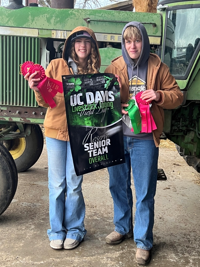 2 youth holding ribbons and a poster-Reserve Senior Team Overall