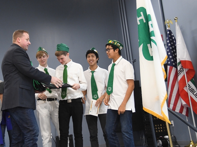 Vacaville Mayor Ron Rowlett congratulates the Chili Cowtown Boys, winner of the Solano County 4-H Chili Cook-Off. From left are Ian Weber, Xander Lovell Francis Agbayani, and Matthew Agbayani.  (Photo by Kathy Keatley Garvey)