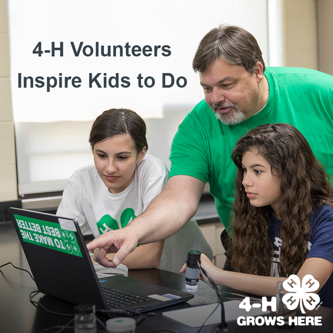 4-H volunteers inspire kids to do - image of adult looking at laptop with 2 girls