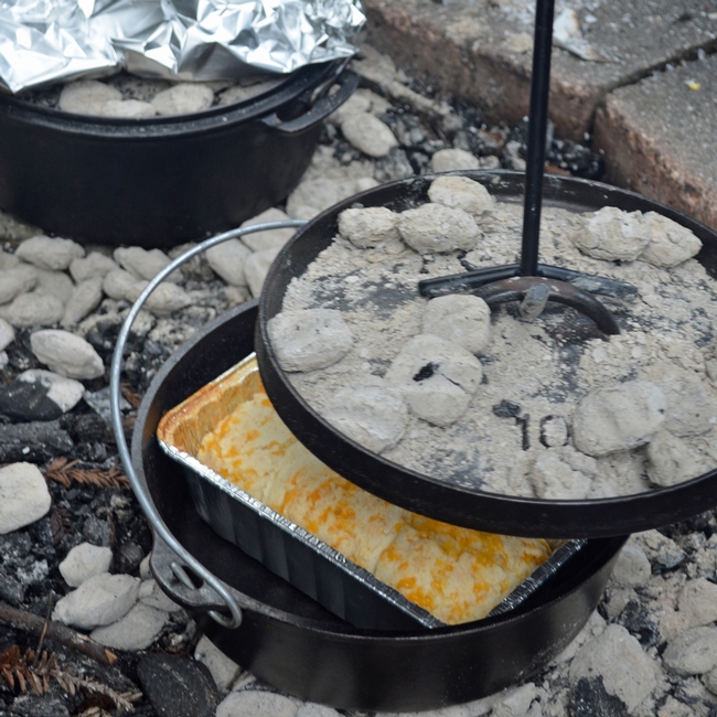Cooking with a dutch oven on campfire.
