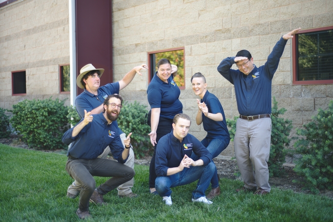 6 people in dark blue shirts posing in a fun way