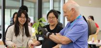 A UC Master Gardener volunteer hands out tomato plants to attendees. All photos by Saoimanu Sope. for Healthy Communities Blog Blog