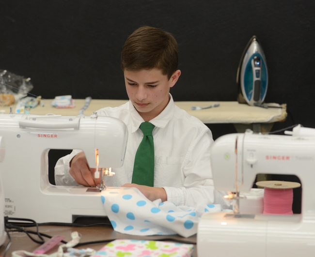 Ryan Anenson of the Tremont 4-H Club, Dixon, won a gold award for his presentation on “Robotic Engineering” and then sewed a flannel blanket for the “Cuddle Me Close” project. (Photo: Kathy Keatley Garvey)