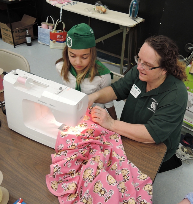 Longtime 4-H leader Audrey Ritchey of the Tremont 4-H Club, Dixon, shows Lillie Sheppard of the Vaca Valley 4-H Club, Vacaville, how to make a 