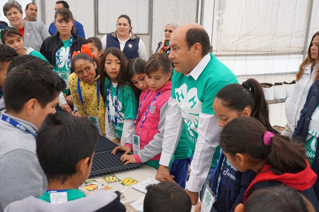 Raúl Nuño, a member of the Baja California Agriculture Department, helps children prepare to plant seeds. (Click the photos to download high-resolution versions.)