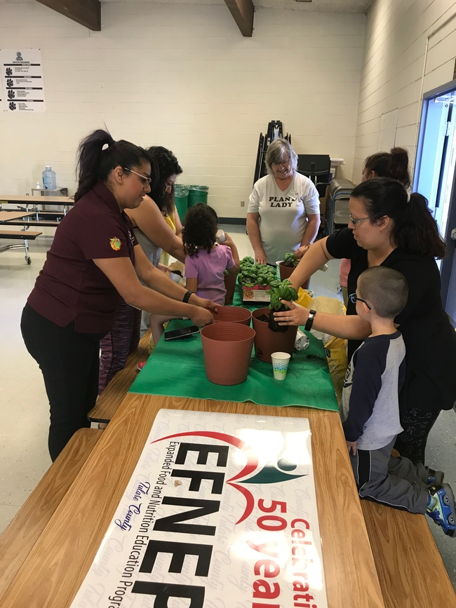 EFNEP participants and their children learn about gardening from UC Master Gardener Dana Young.