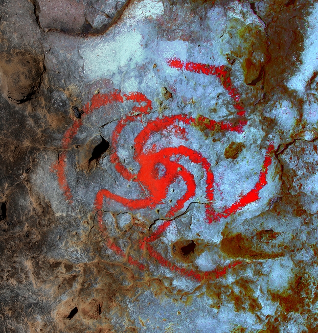 Scientists believe a red pinwheel painted in a Kern County cave by Native Americans depicts a Datura flower swirling open.