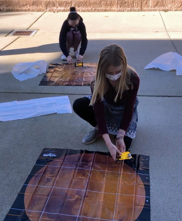 Students drive their rovers on Mars maps. The activities show kids how science, technology, engineering and math can be applied to the world around them.