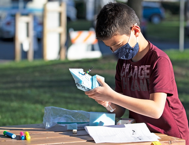 Fifth-grader Sarp Akalin designs and builds a battery-powered motorboat for Engineers Week.