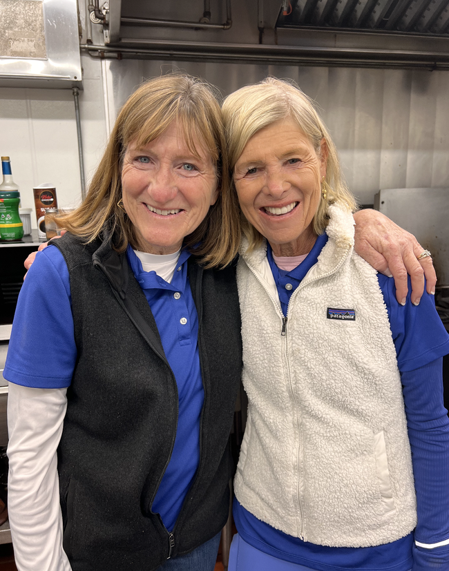 Two women smiling at the camera.