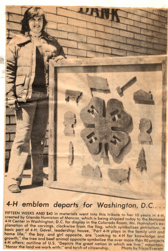 A young woman poses next to a 4-H carving in this archival clipping
