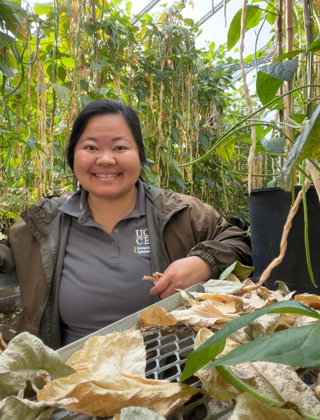 Lilian poses with a long bean varietal project.