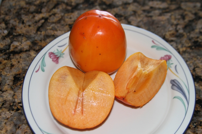 Ripe persimmon on a plate.