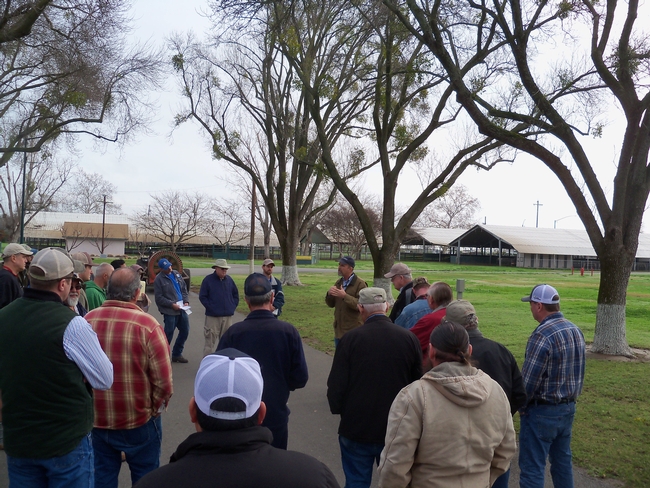 Man speaks to a group of growers at a spray application meeting