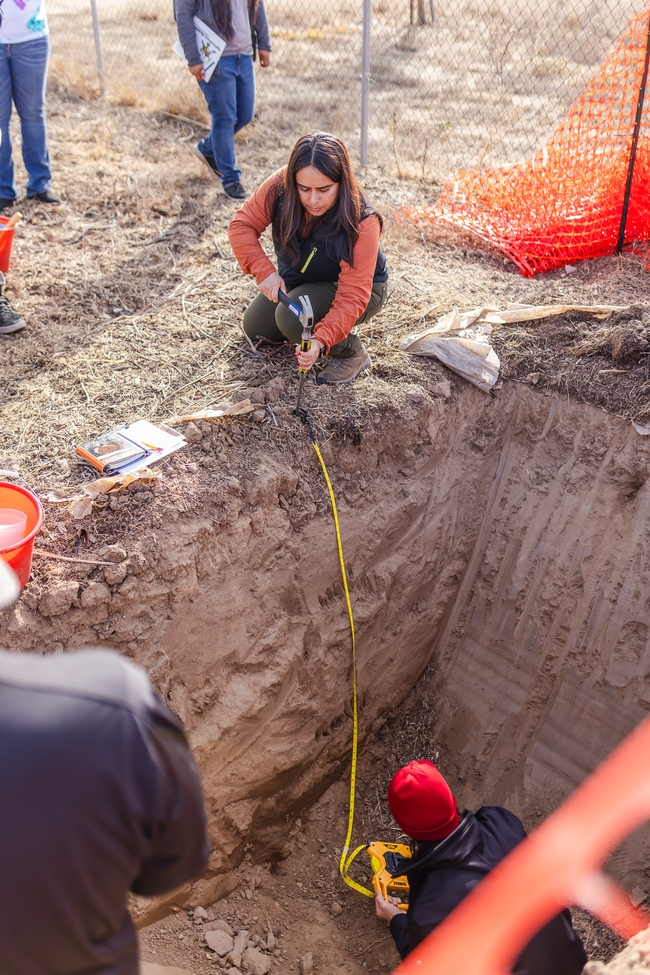 Measuring the soil pit depth.