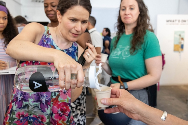 Edith de Guzman pours a sample of water for a taste test