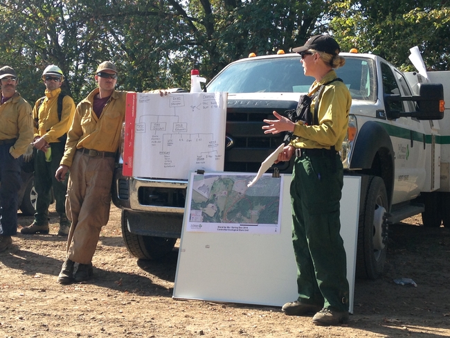 Amanda Stamper, The Nature Conservancy's fire management officer in Oregon, gives instructions to a crew. Women hold only 7 in 100 wildland fire leadership roles.