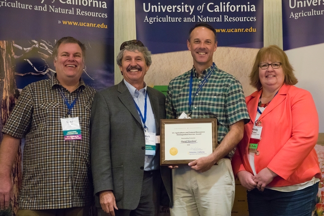 UCCE integrated pest management advisor David Haviland Distinguished Service Award for Excellence in Extension. Pictured in the photo, left to right, are UC ANR executives Chris Greer, Mark Bell, and Wendy Powers.