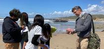 UC Cooperative Extension advisor Igor Lacan, right, describes to 6th grade students some of the plants and animals that live in the water at the beach. for Green Blog Blog