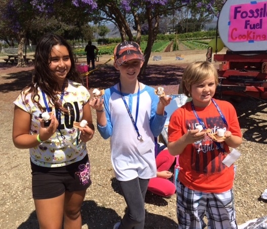 4-H Community Club members at Sustainable You! Summer Camp. Discovering alternative energy with solar oven s'mores.