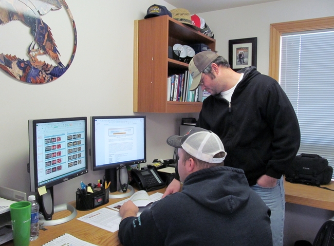 IREC Staff Research Assistants Skyler Peterson and Kevin Nicholson review a research report.