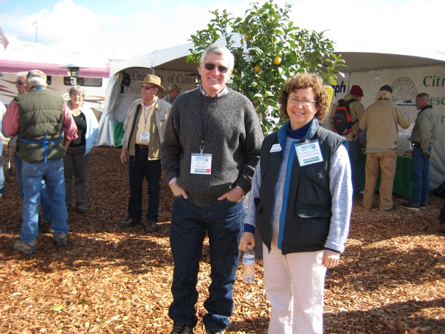 Director of the REC system Bill Frost visits Beth Grafton-Cardwell, director  of Lindcove Research and Extension Center, in a booth shared with the  Citrus Research Board.